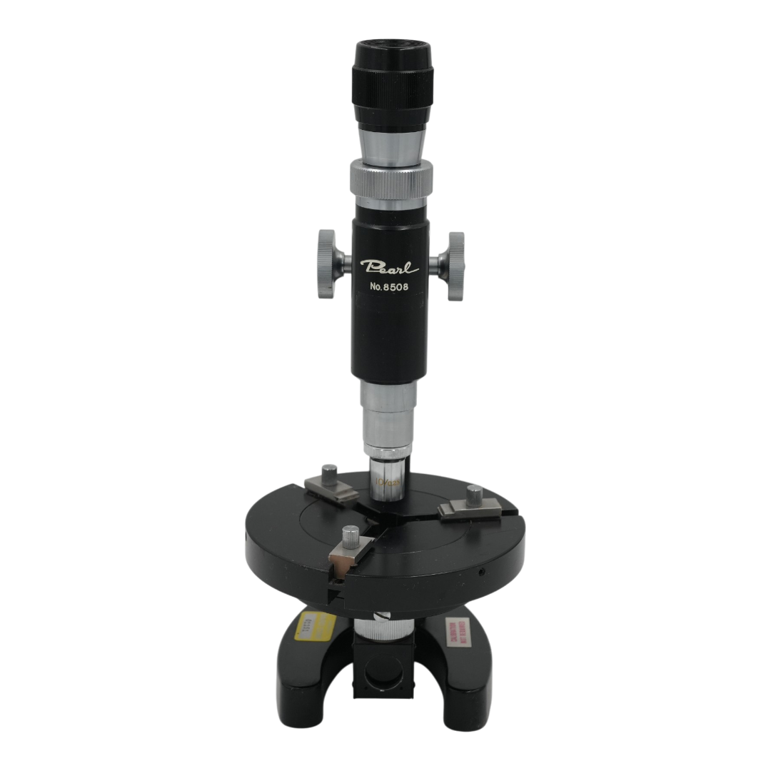 A black and silver Pearl microscope with a central column, adjustment knobs, and a circular base, shown against a transparent background.