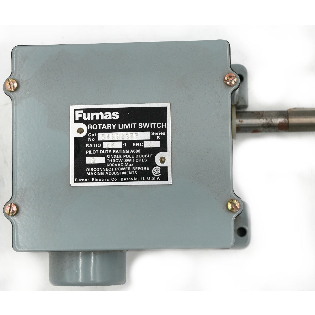 A Furnas rotary limit switch motor housing in a muted gray color, featuring a silver metal mounting plate with screw holes and a black-and-white product label. A metal shaft extends from the right side, and a gray plastic connector is visible at the bottom, all set against a plain white background.